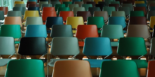 Rows of multi-colored empty chairs