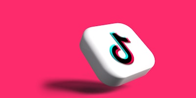 The TikTok logo on a pink background