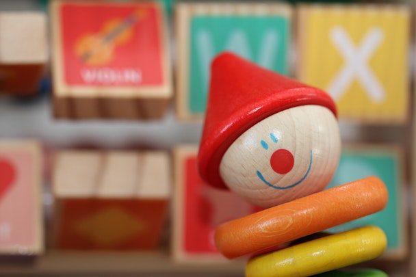 A wooden children's toy that looks like a clown