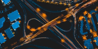 Car headlights from above, blurring into an infinity symbol