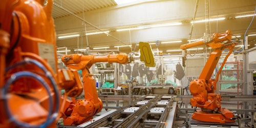 A factory's assembly line, featuring large orange machines