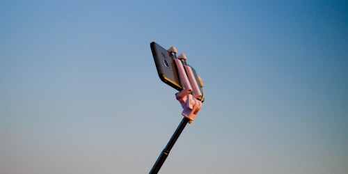 A smartphone on a selfie stick