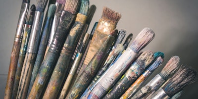 An array of dirty paintbrushes