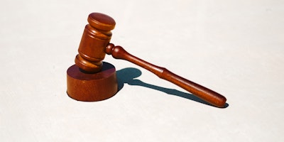 A judge's gavel on a white background