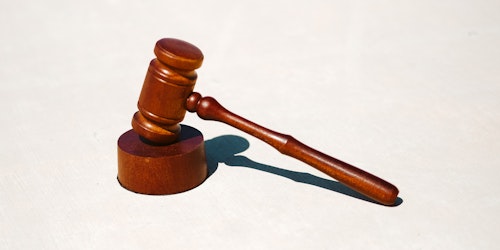 A judge's gavel on a white background