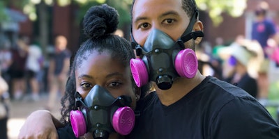 A live event with two people wearing face masks