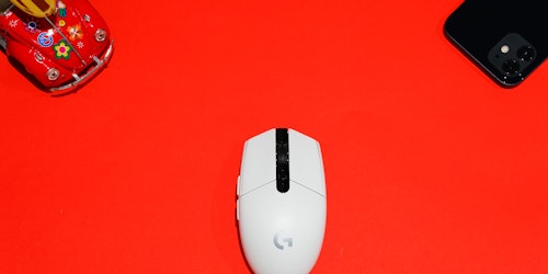 A computer mouse with Google branding on a red background