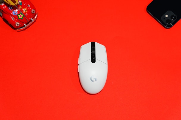 A computer mouse with Google branding on a red background