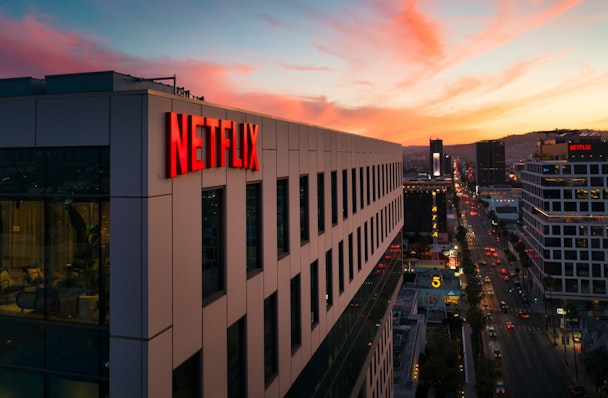 The Netflix logo on a building during a California sunset