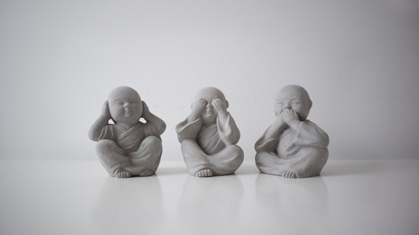 Three statues in the "see no evil, hear no evil, speak no evil" formation