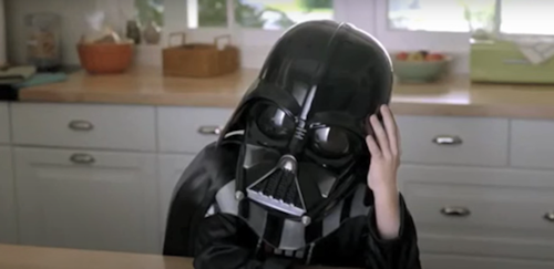A small boy in a Darth Vader costume