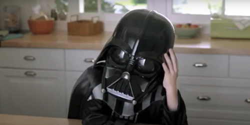 A small boy in a Darth Vader costume
