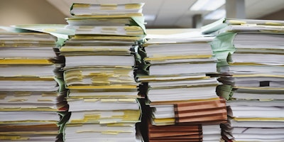 Piles of paper on a desk