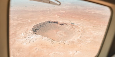 A view of a meteor crater from an airplane window