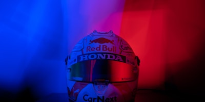A formula one helmet featuring many sponsors