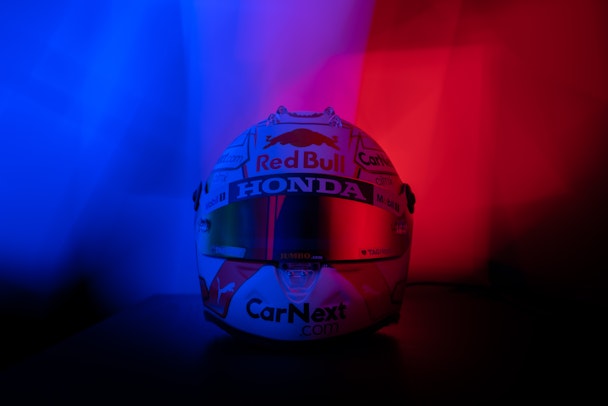 A formula one helmet featuring many sponsors