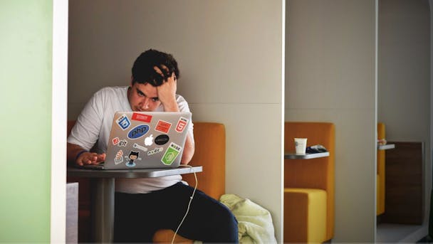 A marketer (man) has his head in his hands as he struggles to make Google Ads work on his laptop A marketer (man) has his head in his hands as he struggles to make Google Ads work on his laptop