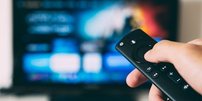 A remote control pointing at a connected TV aka CTV