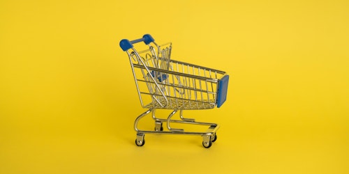 A retail shopping trolley amid a yellow background