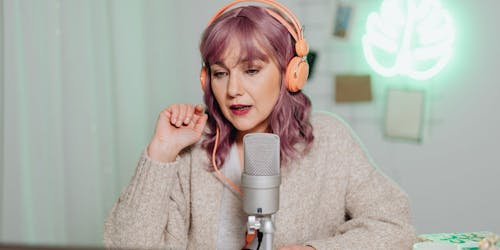 A woman podcasts with headphones on A woman podcasts with headphones on
