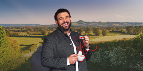 Adam Richman holding a cup of tea with the Union Jack 
