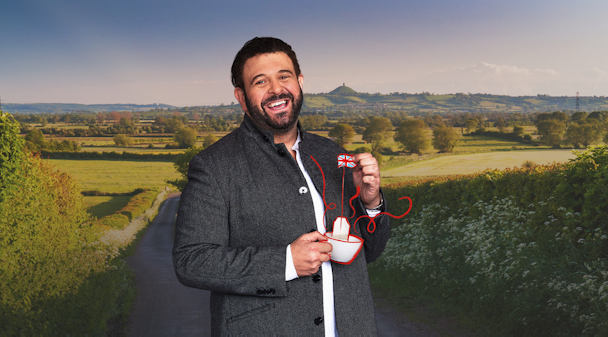 Adam Richman holding a cup of tea with the Union Jack 