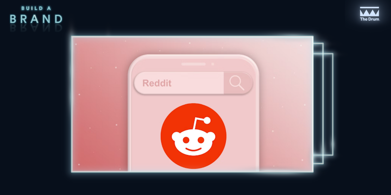 Reddit logo on pink backdrop 