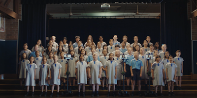 A children's choir performs with sick children attending via robots 