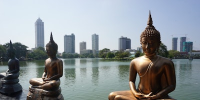 Images of Budhas in front of office towers in Sri Lanka
