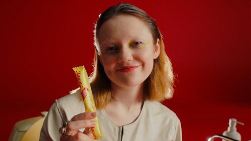 girl holding a pregnancy test in tampon packaging
