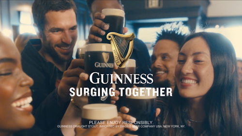 people toasting pints of guinness