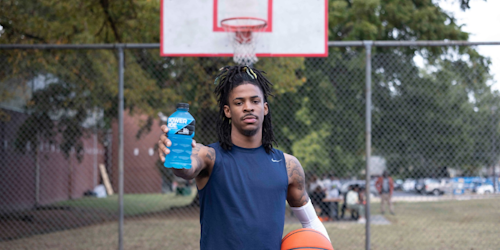 ja mourant holding powerade and a basket ball