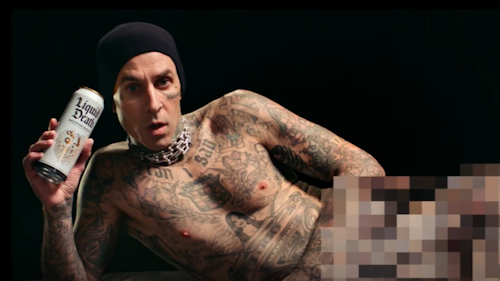 travis barker holding a can of liquid death
