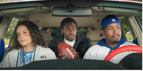 three football fans in a car