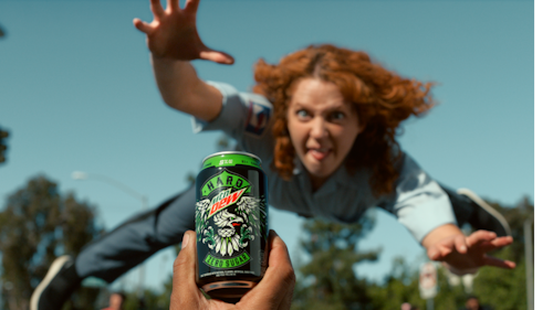 a woman jumps to get her hands on a hard mtn dew