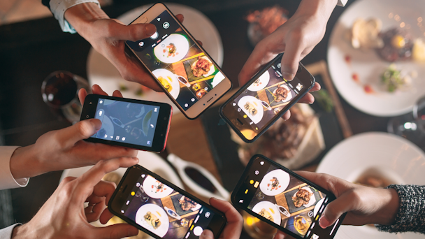 people taking photos of food with their phones