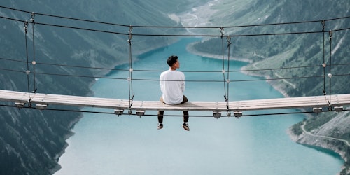 Man sitting on bridge in the alps