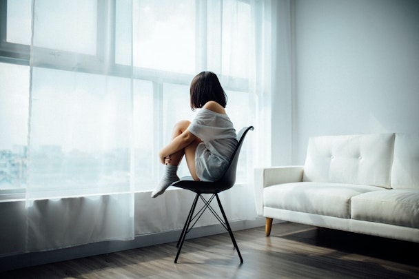 Woman sat on chair facing window