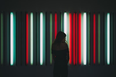 Woman standing in front of neon lights