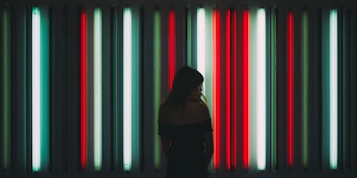 Woman standing in front of neon lights