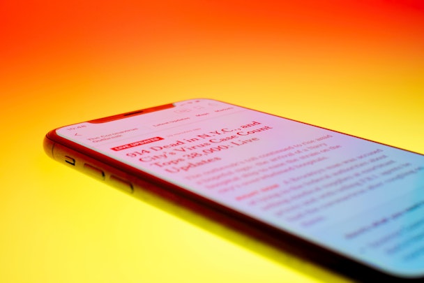 Close-up of news article on phone in brightly saturated colors