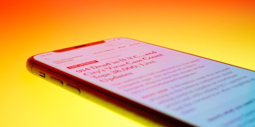 Close-up of news article on phone in brightly saturated colors
