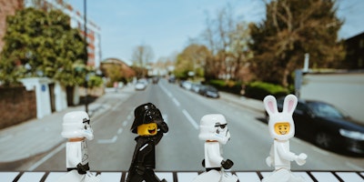 Four lego people on a pedestrian crossing