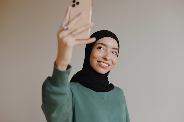 Woman holding up iPhone 6 in selfie mode