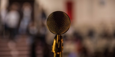 Selective focus shot of brass-colored microphone