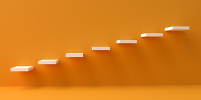 3D image of white ascending steps against orange background