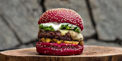 Burger on wooden chopping board