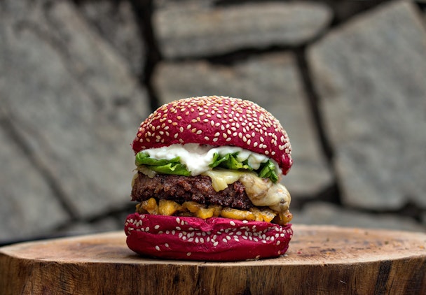 Burger on wooden chopping board