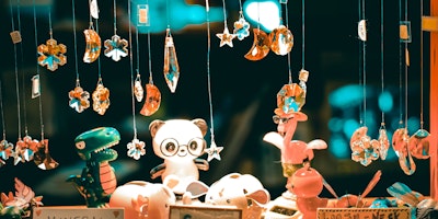 A toy dragon and a toy panda beneath hanging gems