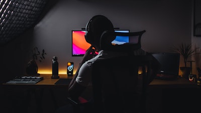 Man sat in dark at computer